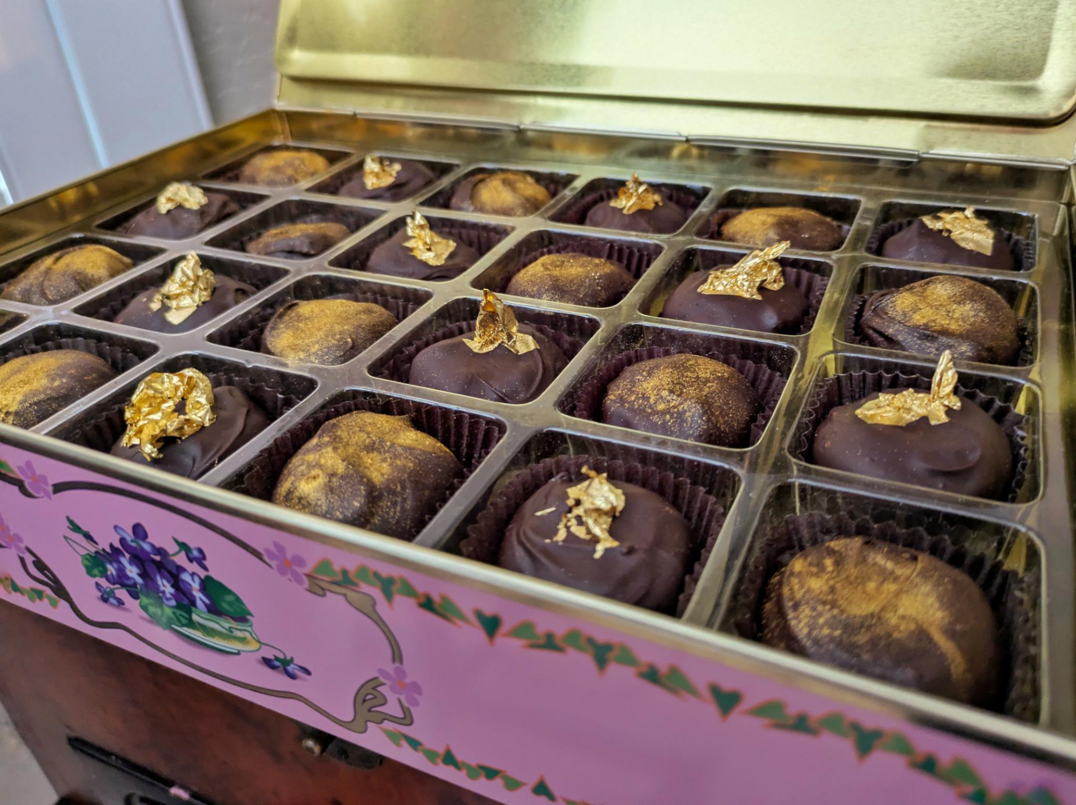 Edible gold accents on hand-dipped chocolates